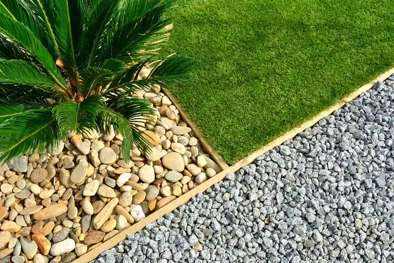 Modern garden with synthetic grass, river stones, and gravel Modern garden with synthetic grass, river stones, and gravel
