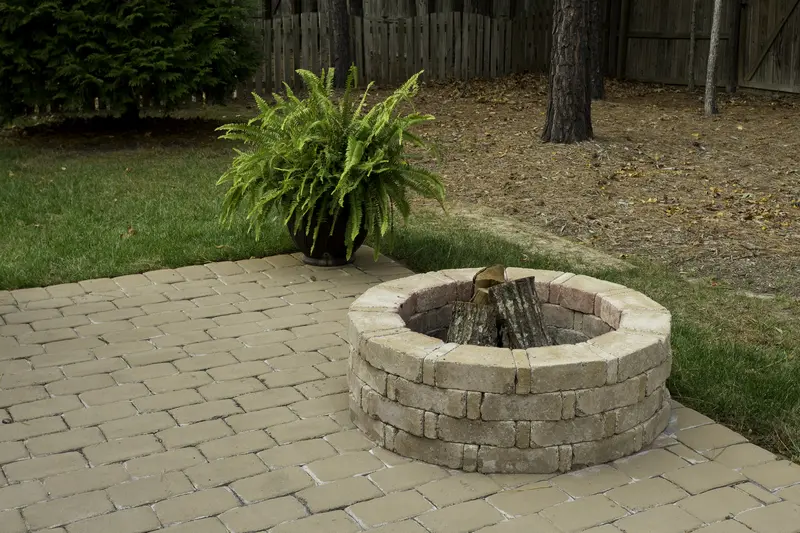 Custom brick fire pit on a professionally installed paver patio in backyard. Custom brick fire pit on a professionally installed paver patio in backyard.