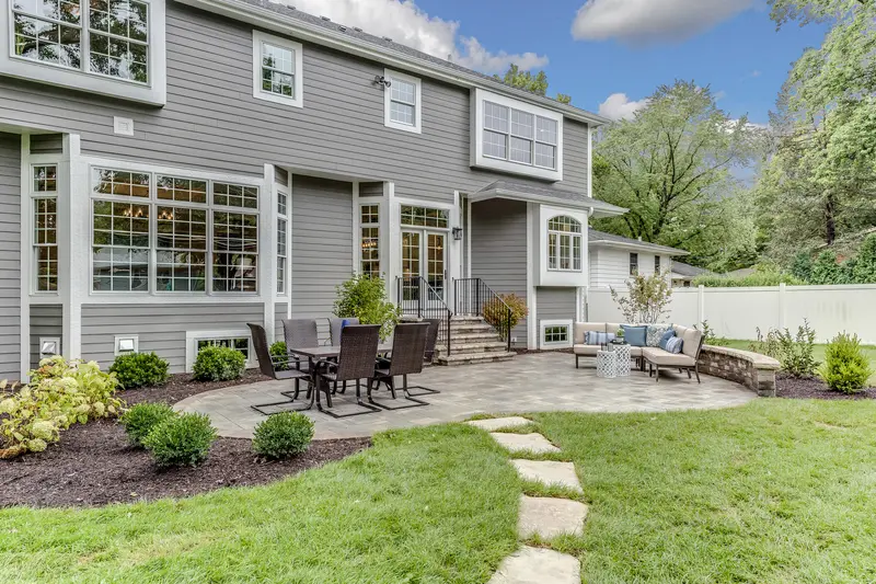 Backyard patio with custom stone pavers and comfortable outdoor seating